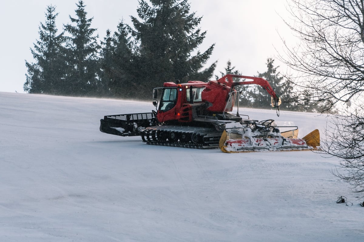 Catskiing Kazakhstan — red snowcat in Altai Mountains backcountry