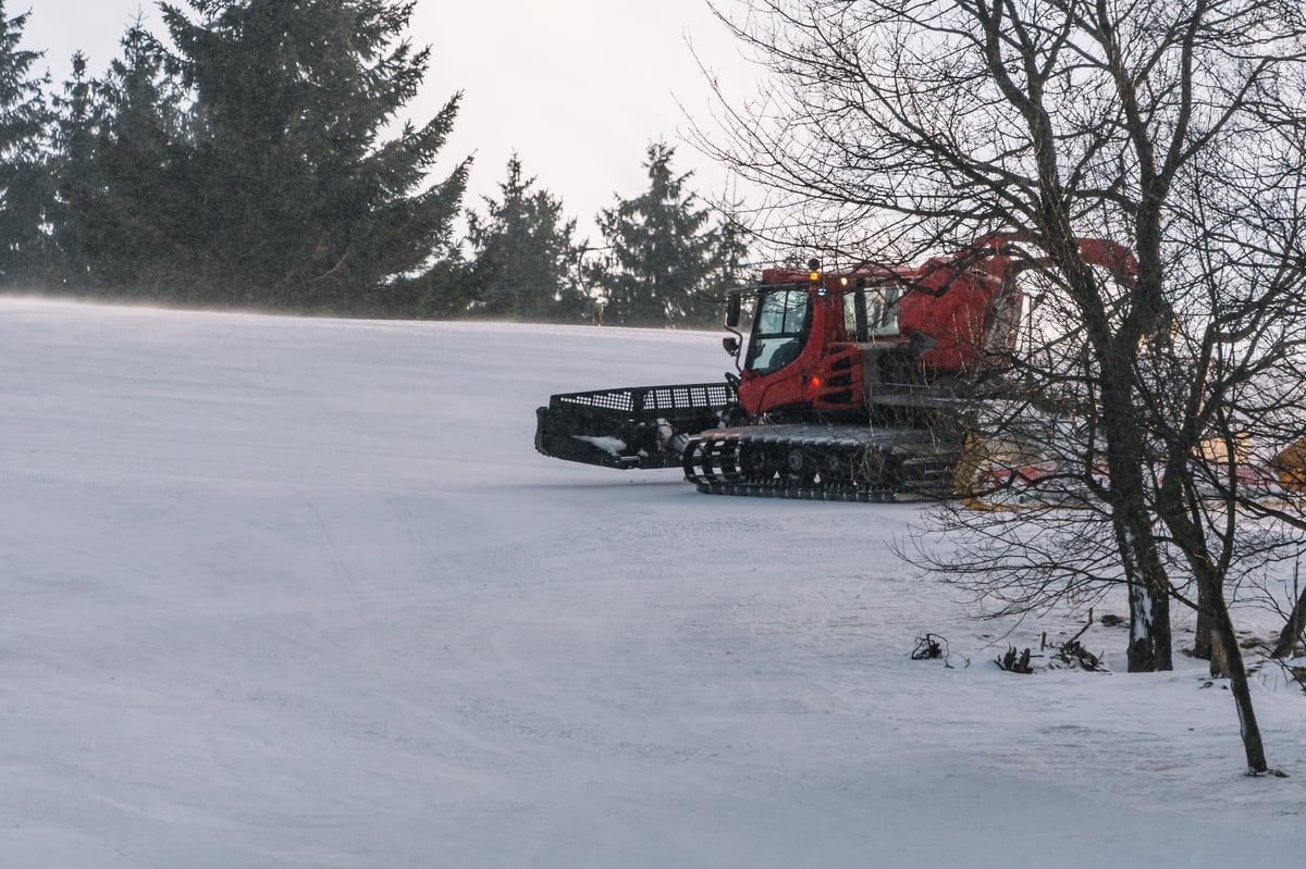 Catskiing Kazakhstan — red snowcat in deep Altai powder